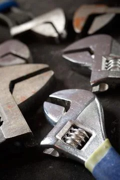 Wrenches of different sizes on a black table Stock Photos