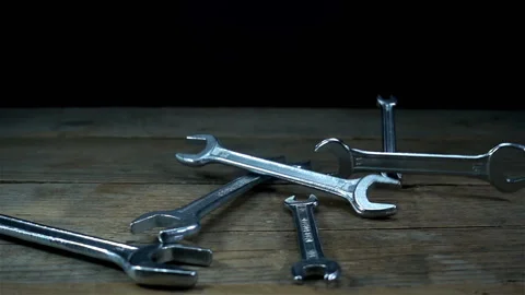 Wrenches falling in slow motion on black Stock Footage 134179508