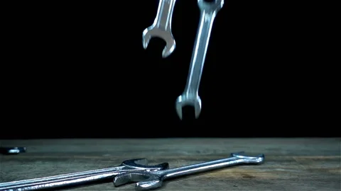 Wrenches falling in slow motion on a black Stock Footage 134731928