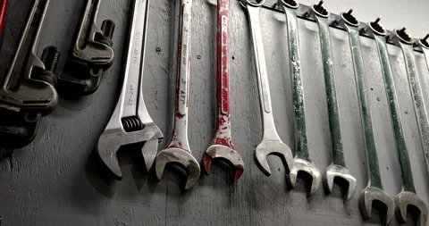 Wrenches hang on the wall in a machine workshop Stock Footage 287486128