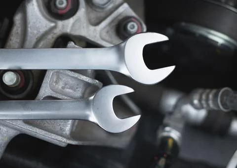 Wrenches lie on the engine of the car in the engine compartment. Stock Photos