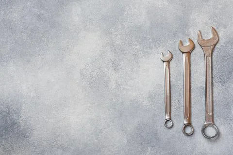 Wrenches, tools on gray concrete background with copy space. Stock-Fotos