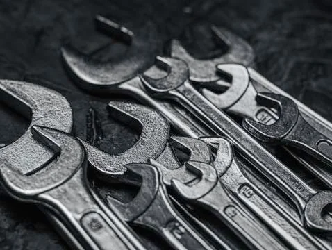 Wrenches, tools on grey stone table. Worker tools and equipments close-up. Stock Photos