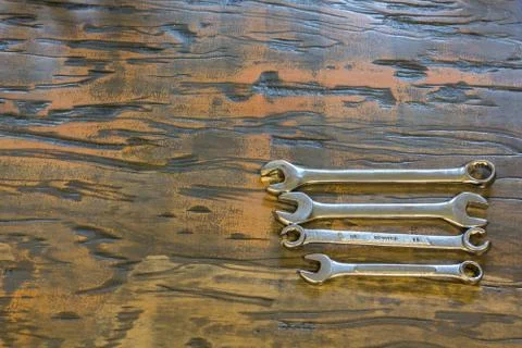 Wrenches on a wood background Stock Photos