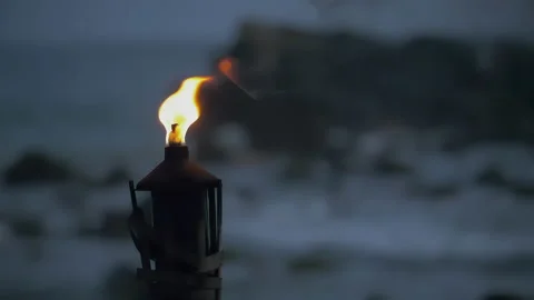 Wriggling flame of torch against dark gray blurred background. Blurred Stock Footage 222579053