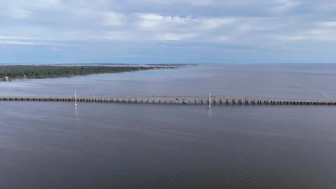 Wright Memorial Bridge Over Calm Ocean Under Bright Sunlight With Reflective Stock Footage 317650126