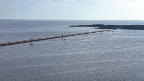 Wright Memorial Bridge Over Calm Ocean Under Bright Sunlight With Reflective Stock Footage 317650388