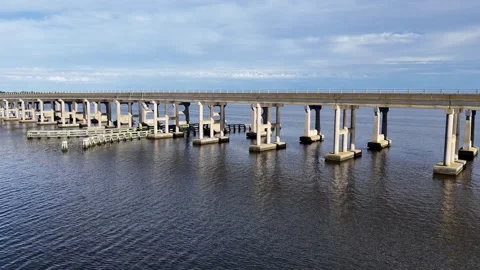 Wright Memorial Bridge Over Calm Ocean Under Bright Sunlight With Reflective Stock Footage 317650657