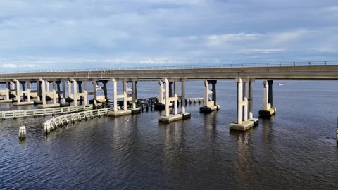 Wright Memorial Bridge Over Calm Ocean Under Bright Sunlight With Reflective Stock Footage 317651169