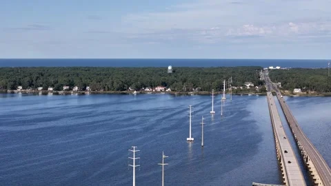 Wright Memorial Bridge Over Calm Ocean Under Bright Sunlight With Reflective Stock Footage 317651426