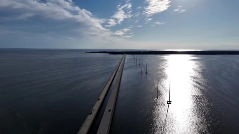 Wright Memorial Bridge Over Calm Ocean Under Bright Sunlight With Reflective Stock Footage 317651623