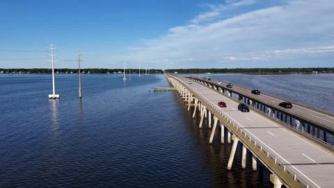 Wright Memorial Bridge Over Calm Ocean Under Bright Sunlight With Reflective Stock Footage 317651896