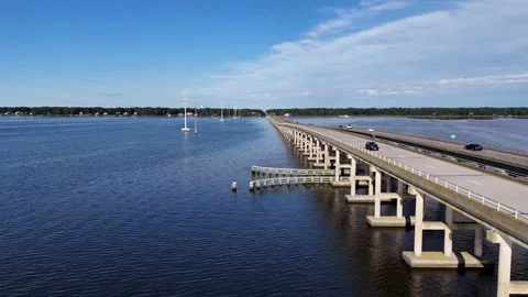 Wright Memorial Bridge Over Calm Ocean Under Bright Sunlight With Reflective Stock Footage 317652015