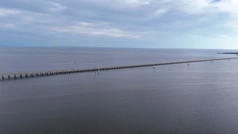 Wright Memorial Bridge Over Calm Ocean Under Bright Sunlight With Reflective Stock Footage 317652036