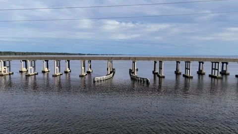 Wright Memorial Bridge Over Calm Ocean Under Bright Sunlight With Reflective Stock Footage 317652112