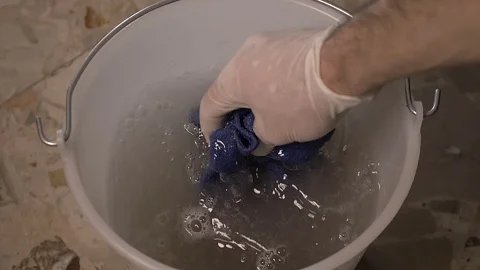 Wring out the rag in the bucket Stock Footage 125524636