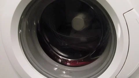 Wringing out the laundry in the washing machine Stock Footage 167806620