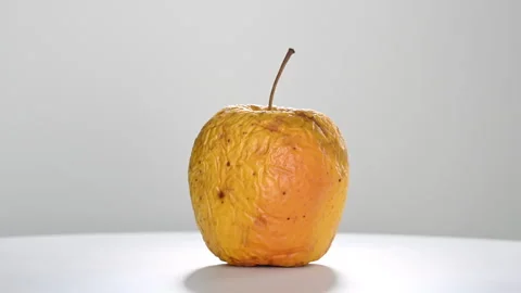 Wrinkled old apple rotating on white background Stock Footage 333124887