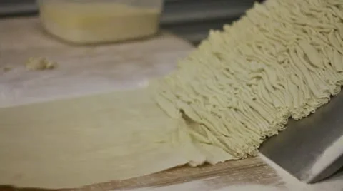 Wrinkling dough with machine pan right Stock Footage 9434204