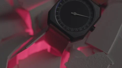 Wrist watch presented on white flakes against pink light Stock Footage 87160551
