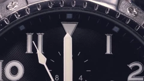 A wristwatch dial with hands passing 12 o'clock. Close up shot. Stock Footage 292137705