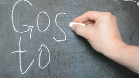Write on the blackboard with white chalk. School invitation. Stock Footage 113691818