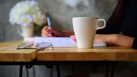 Write a book and have coffee in a coffee shop. Stock Footage 80411903