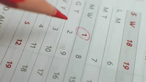 Write the day on a paper calendar with a red pen Video stock 205924025