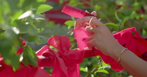 Write down what you want on a red cloth and tie it with the belief. Stock Footage 310631066