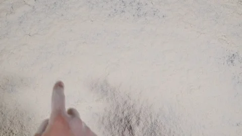 Write a finger LOVE on a white flour background. top view 4k Stock Footage 90293847