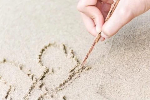 Write Heart on sand Stock Photos