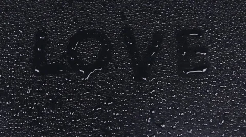 Write  love on a wet black background, approaching, movement, Video stock 55194979
