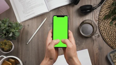 Write message on smartphone with green chroma key screen. Top view. Male hands. Stock Footage 129318750