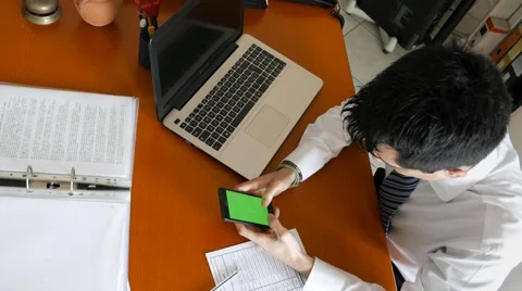 Write messages on a cell phone instead of working, green screen Stock Footage 60693275