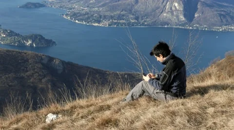 Write messages to mobile phone in front of a nice view Stock Footage 59724904