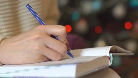 Write a New Year's wish in a notepad Stock Footage 83099677