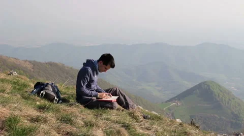 Write in a notebook in solitude on the mountain top Stock Footage 49606368
