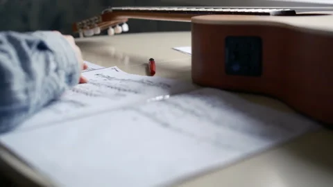Write with pen, make notes education classical guitar, notes on table Stock Footage 304582930