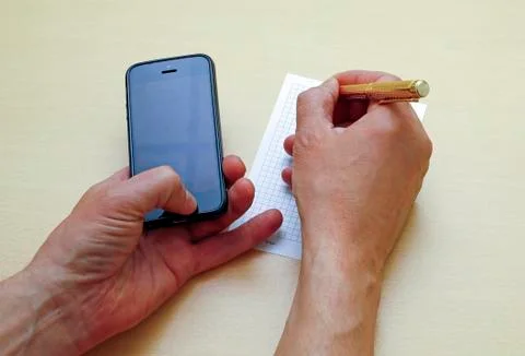 Write to a piece of paper information from your phone Stock Photos