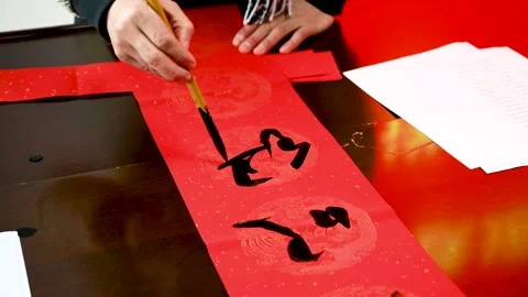 Write Spring Festival couplets during the Chinese Spring Festival Stock Footage 168729554