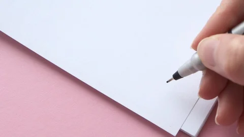 Write thanks on white notepad paper. Female hand holding pen note or letter Stock Footage 129198888