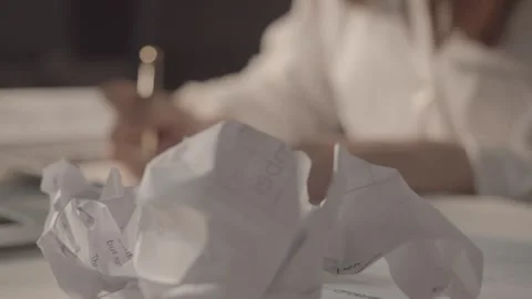 Writer Typing on Laptop Surrounded by Crumpled Paper Drafts, Close-up Vídeos de archivo 334640677