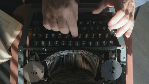 Writer typing with retro writing machine. Sun lights on the hand. Stock Footage 116673842