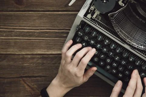 Writer typing with retro writing machine. Stock Photos