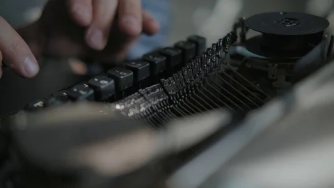 Writer typing on a typewriter, taken from side. Vintage scene Stock Footage 116673951