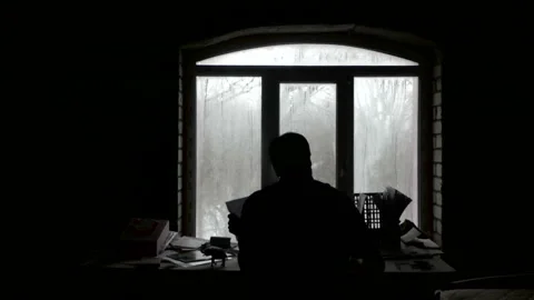 A writer writes in the dark by the window Stock Footage 86594872
