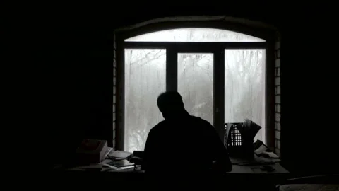 A writer writes in the dark by the window Stock Footage 86595091