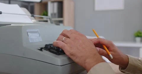 Writers hands type on vintage typewriter in office, holding pencil while typing Stock Footage 328304696