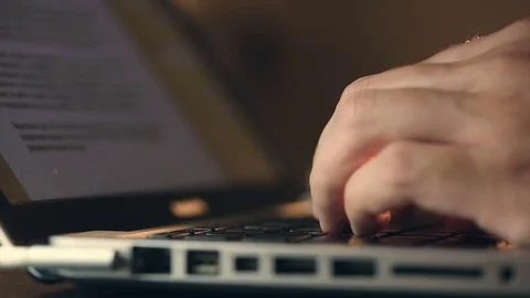 Writer's hands typing on a laptop keypad Video stock 80675351