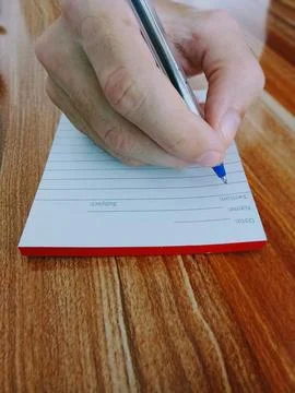 Writes down in a notebook Photos